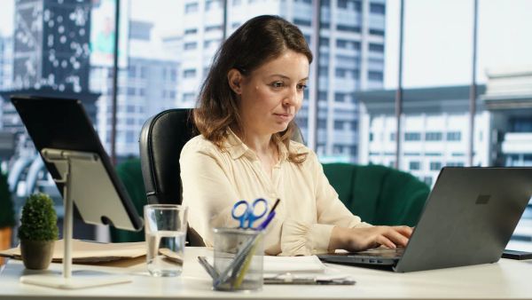 Business owner planning her multi-location strategy at her desk