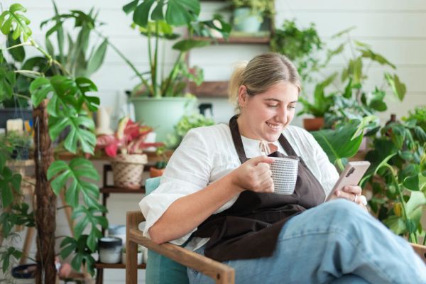 Small business owner checking her website on a smartphone