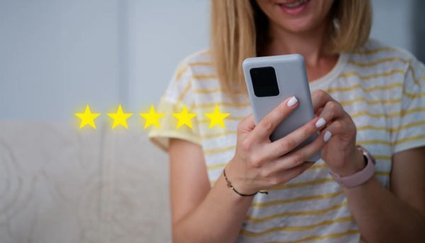 Customer leaving a five-star review on her phone