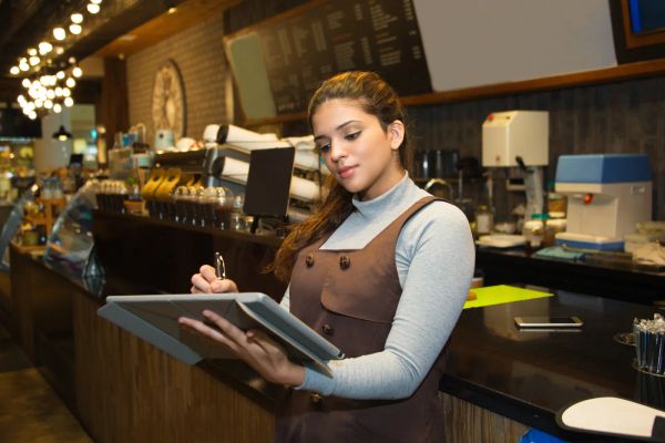 Restaurant owner going over the books at the counter