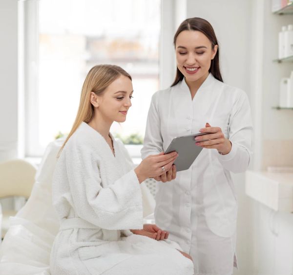 Med spa professional consulting with a client at the clinic