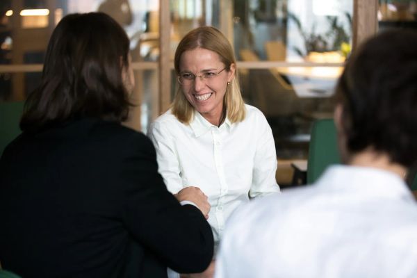 Business owner shaking hands with a new web designer at a meeting