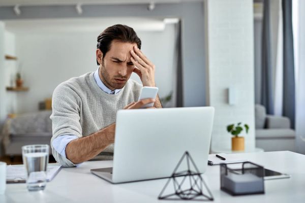 Business owner struggling with a website on his phone