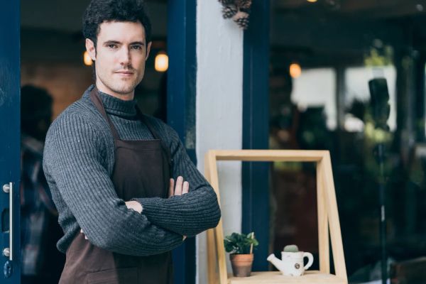 Restaurant owner standing proudly in his cafe