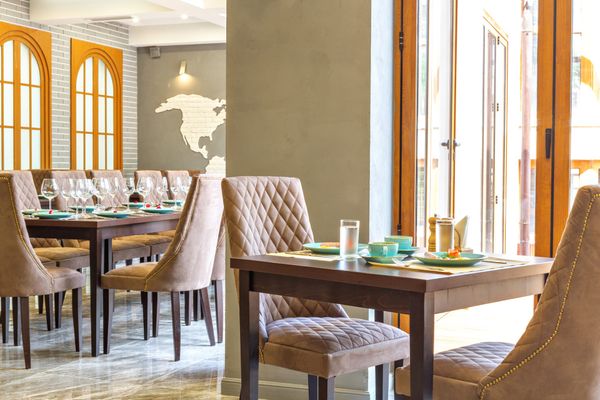 Elegantly set restaurant table by a sunlit window