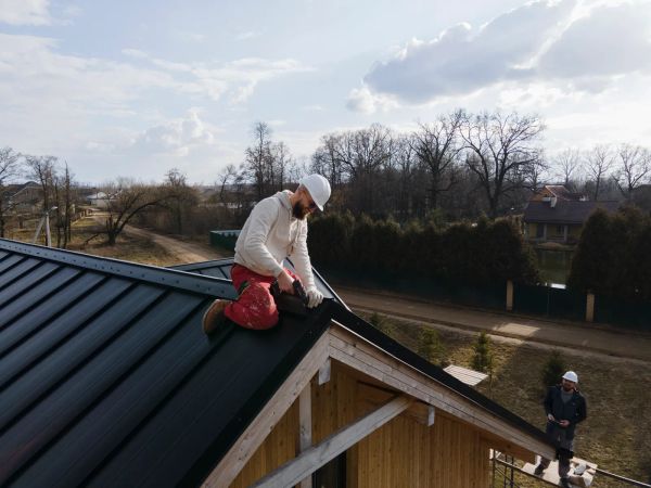 Roofer working on a roof in a safety helmet