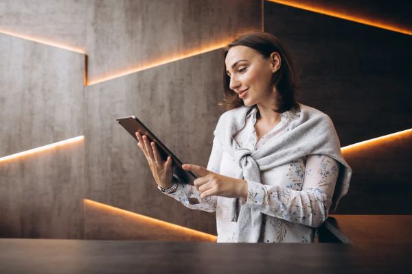 Young business woman reviewing her website on a tablet
