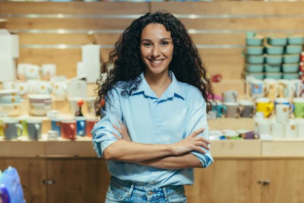 Hispanic small business owner smiling in her gift shop