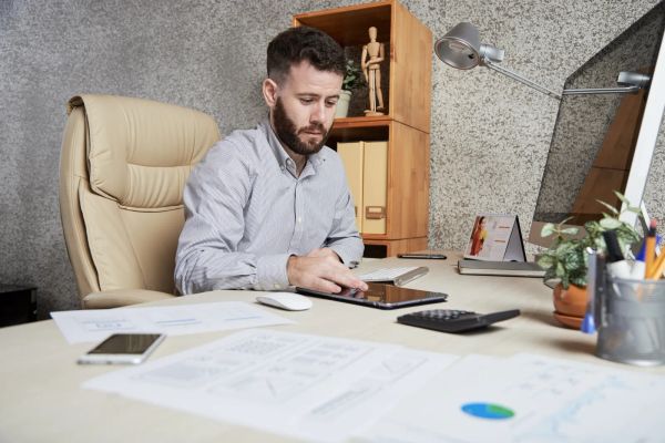 Business owner checking his website on a tablet