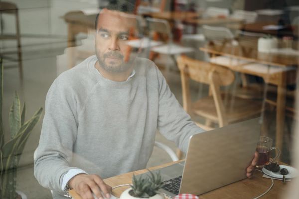 Business owner weighing options while working on a laptop