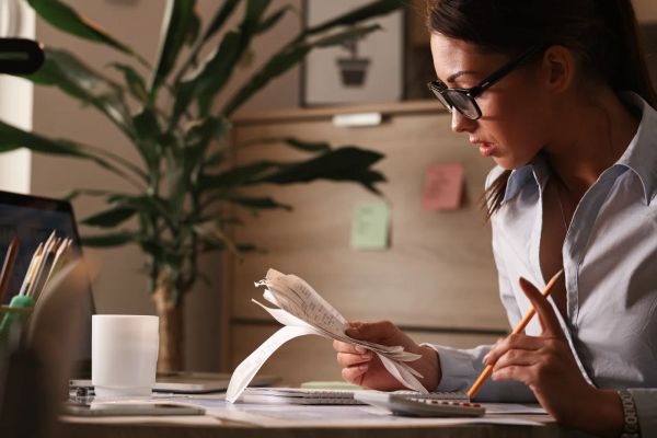 Business owner calculating costs at her desk