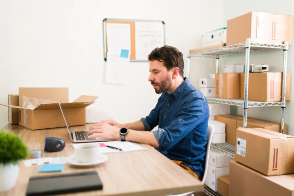 Business owner updating his website on a laptop