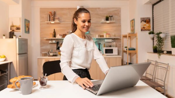 Business owner updating her website in the evening