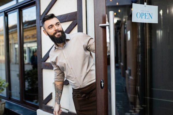 Small business owner at the door of his shop