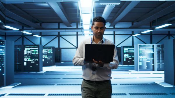 Technician managing web hosting servers in a data center