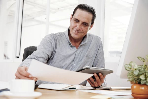 Business owner examining a contract at the office