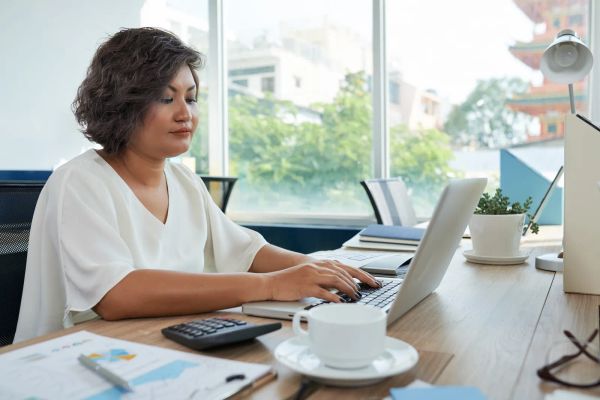 Business owner comparing website options on a laptop