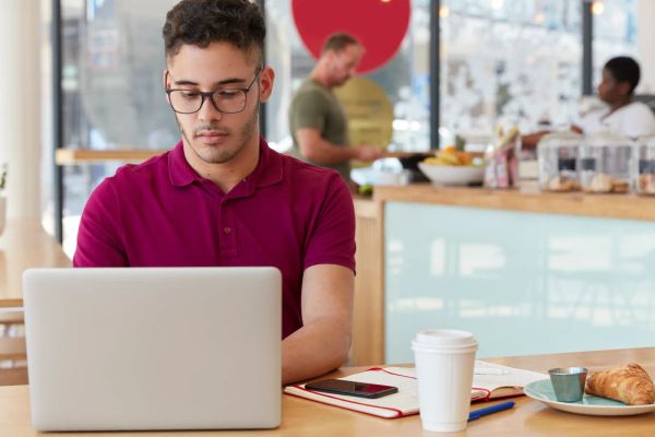Business owner researching website platforms on a laptop